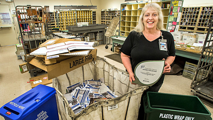 Woman in Post Office holding sign