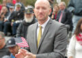 Man claps amid parade crowd