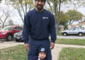 USPS letter carrier and child wearing letter carrier's costume