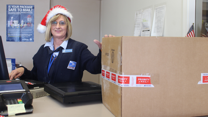 USPS clerk touches package