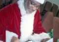 Man dressed as Santa reads letter