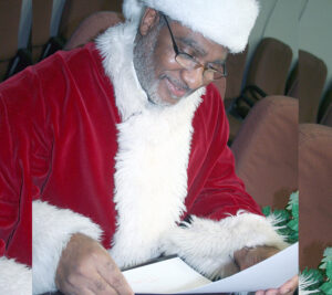 Man dressed as Santa reads letter