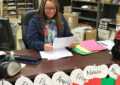 Postmaster reads Santa letters at her desk