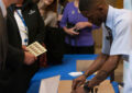 USPS employee serves line of customers