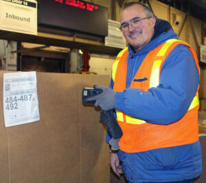 Postal worker scans large package