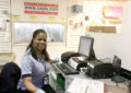 USPS retail worker smiles behind counter