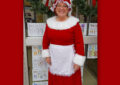 Woman dressed as Mrs. Claus smiles