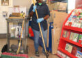 Custodian cleans floor in Post Office lobby