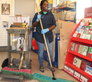 Custodian cleans floor in Post Office lobby