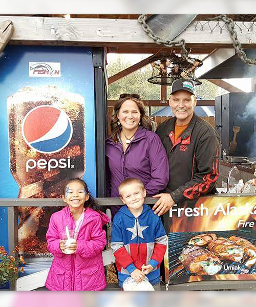 Chuck Pfeifer and family inside their food booth