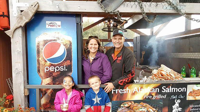 Chuck Pfeifer and family inside their food booth
