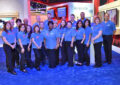 Group of people stand near booth