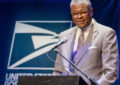 Deputy Postmaster General Ronald Stroman delivers speech at podium