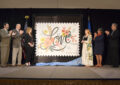 Ceremony participants unveil the Love stamp