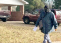 Letter carrier walks through barren neighborhood