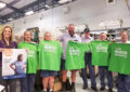 Group of people holding T-shirts