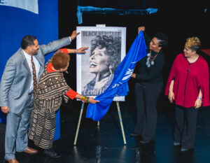 People unveil Lena Horne stamp poster on stage