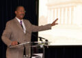 Man speaks at podium