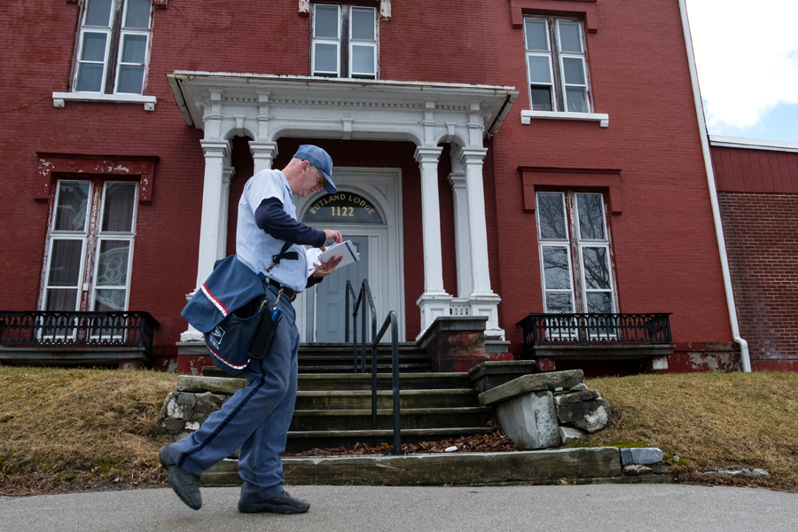 Letter carrier walks through historic downtown