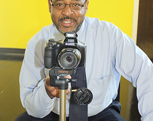 Postal worker holds camera