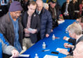 People line up at table for autographs