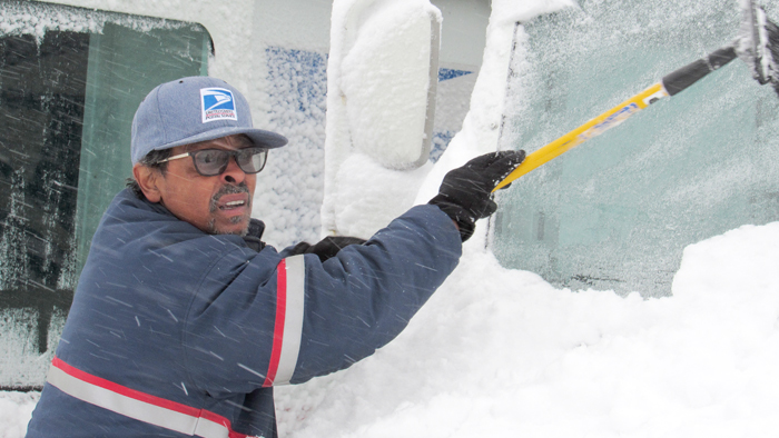 Buffalo, NY, letter carrier clears snow