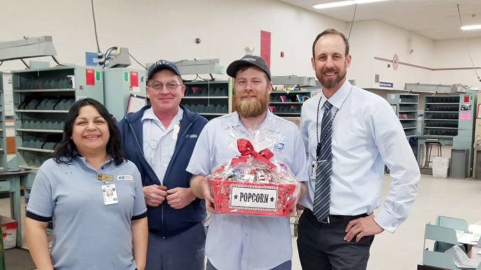 Roy, UT, Postmaster pictured with employees