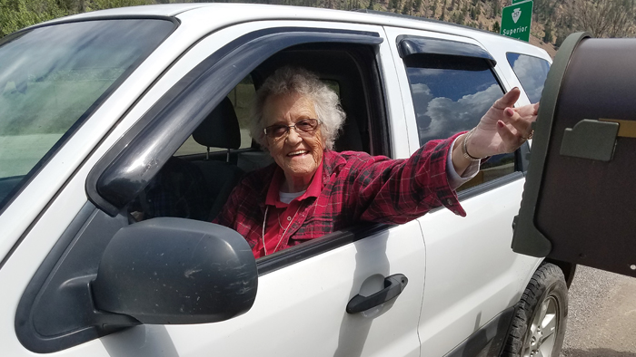 Woman in car at mailbox