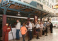 People stand in line inside museum