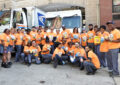 Large group of postal employees gather in front of Post Office