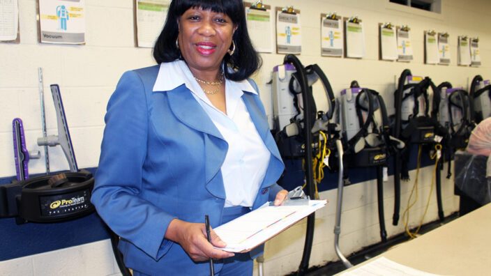 Woman stands in maintenance work room