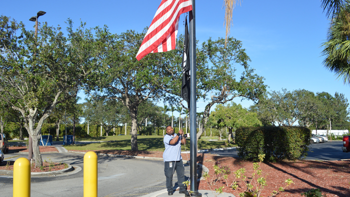 Employee raises the POW-MIA flag