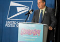 Man in suit speaks at podium