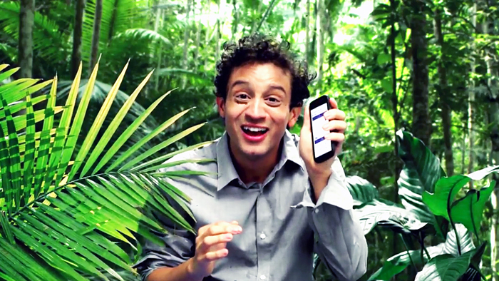 Man standing in forest with cell phone