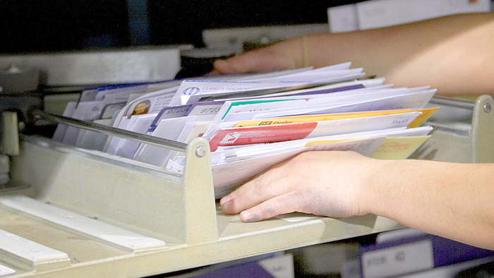 Employee sorting mail