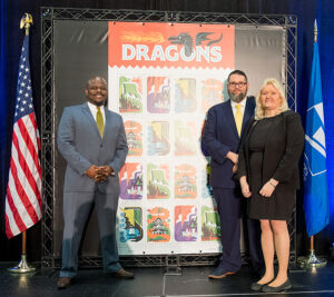 Participants gather near the Dragons stamp artwork