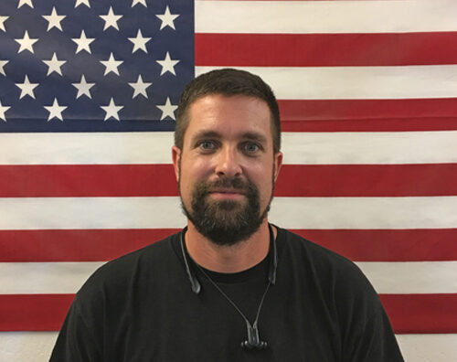 Man in front of U.S. flag