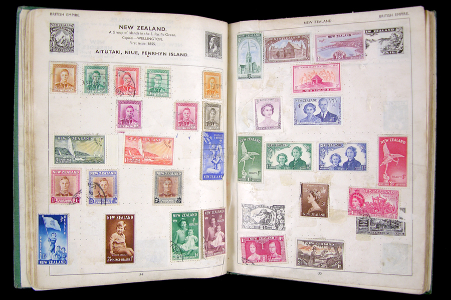 Album pages displaying old stamps featuring Queen Elizabeth II and others