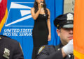 Woman holds microphone and sings