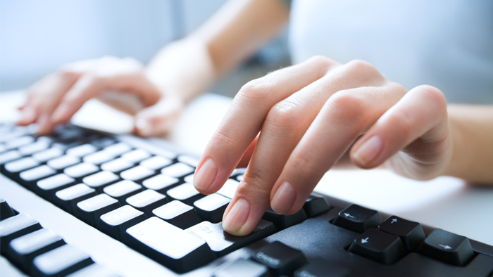 Hands typing on a keyboard