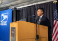 Teenage boy sings at podium