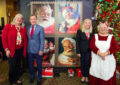 Participants gather near a poster of stamp artwork