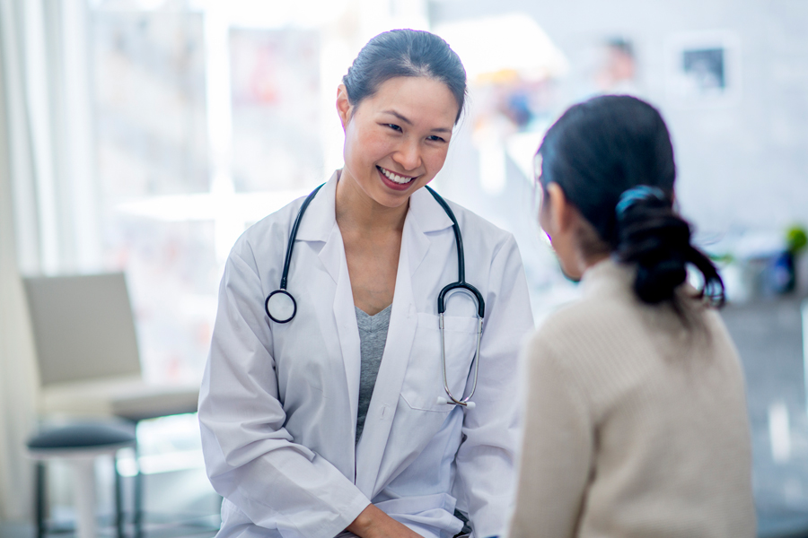 Smiling doctor speaks to patient