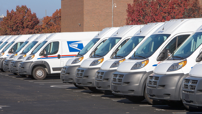 Postal Service vans in parking lot