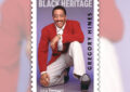 Stamp showing a smiling Gregory Hines kneeling with raised tap shoe