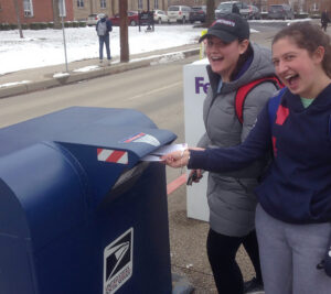 Two students mailing letters