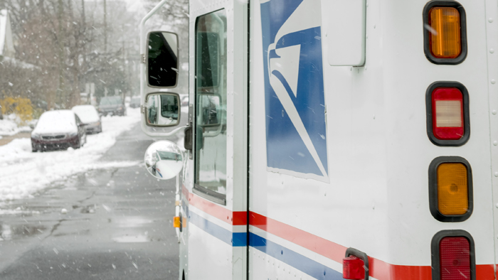 Postal Service vehicle on a snow-covered street
