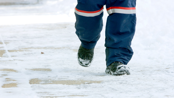 Postal worker walking in the snow