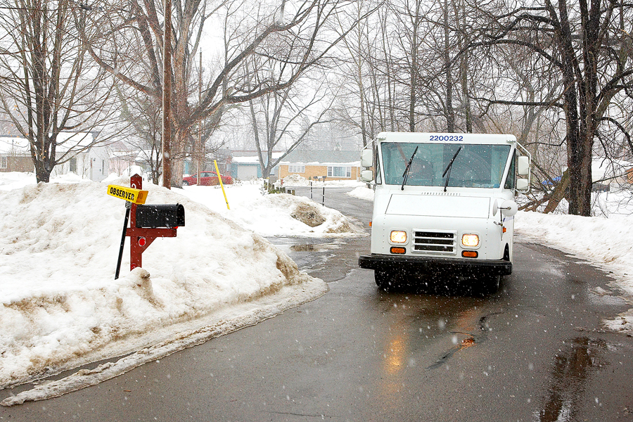 Postal delivery vehicle on snowy road
