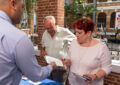 Customers purchase stamps after the ceremony